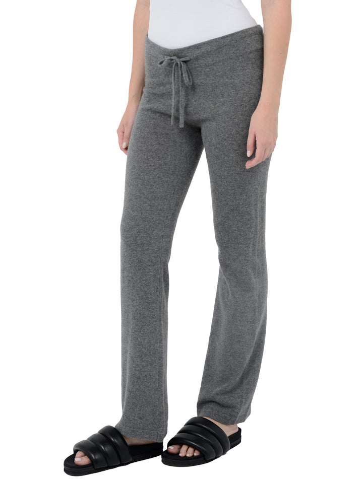3/4 front facing shot of model wearing Kaite in gravel grey. The lounge pants are straight fit and made of cashmere and recycled cashmere.
