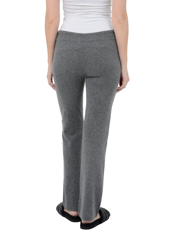 Back facing shot of model wearing Kaite in gravel grey. The lounge pants are straight fit and made of cashmere and recycled cashmere.