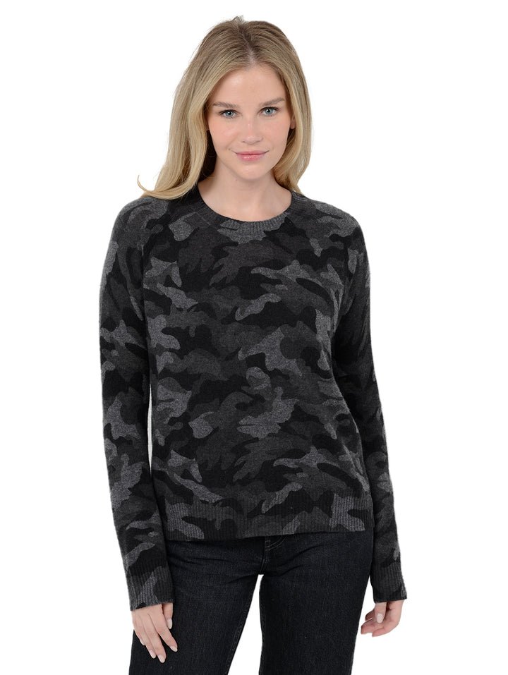 Front facing shot of model wearing Tasha in black. The sweater is straight fit and made of cashmere. The pullover has a all-over camouflage print