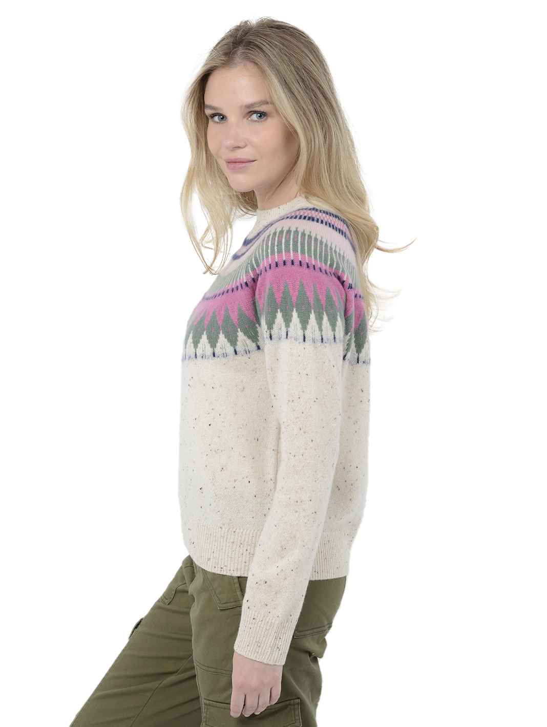 Side view shot of model wearing Salena in Pebble Cream. The sweater is relaxed and made of 100% cashmere. The sweater also sports a fairisle knit design across the chest and neck.