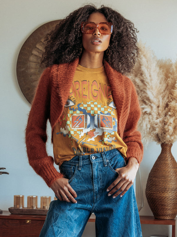 Editorial photo of model wearing the Odi mohair shrug with retro sunglasses and a vintage tee.