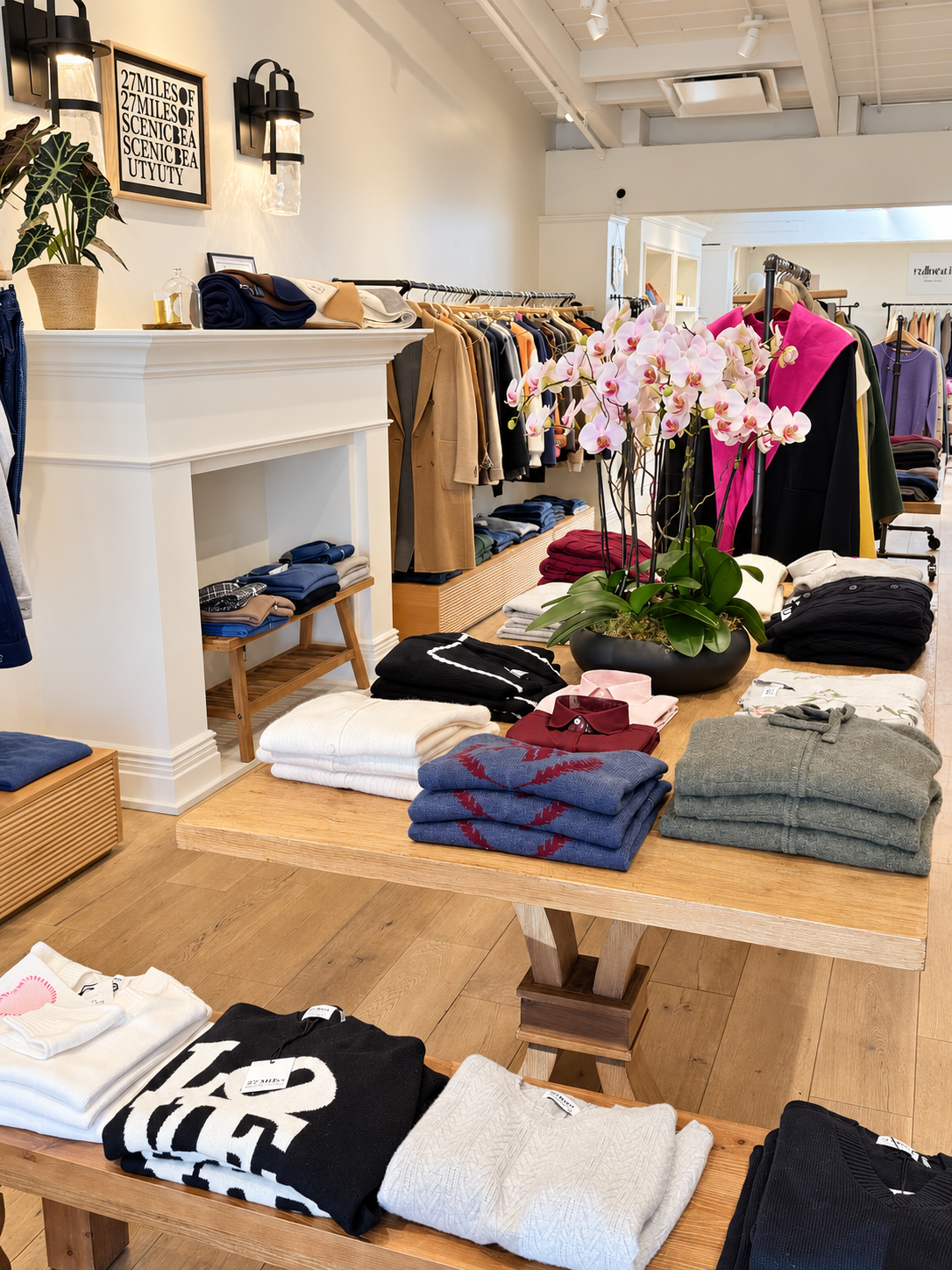 Palo Alto boutique interior with cashmere displays, orchids and white fireplace