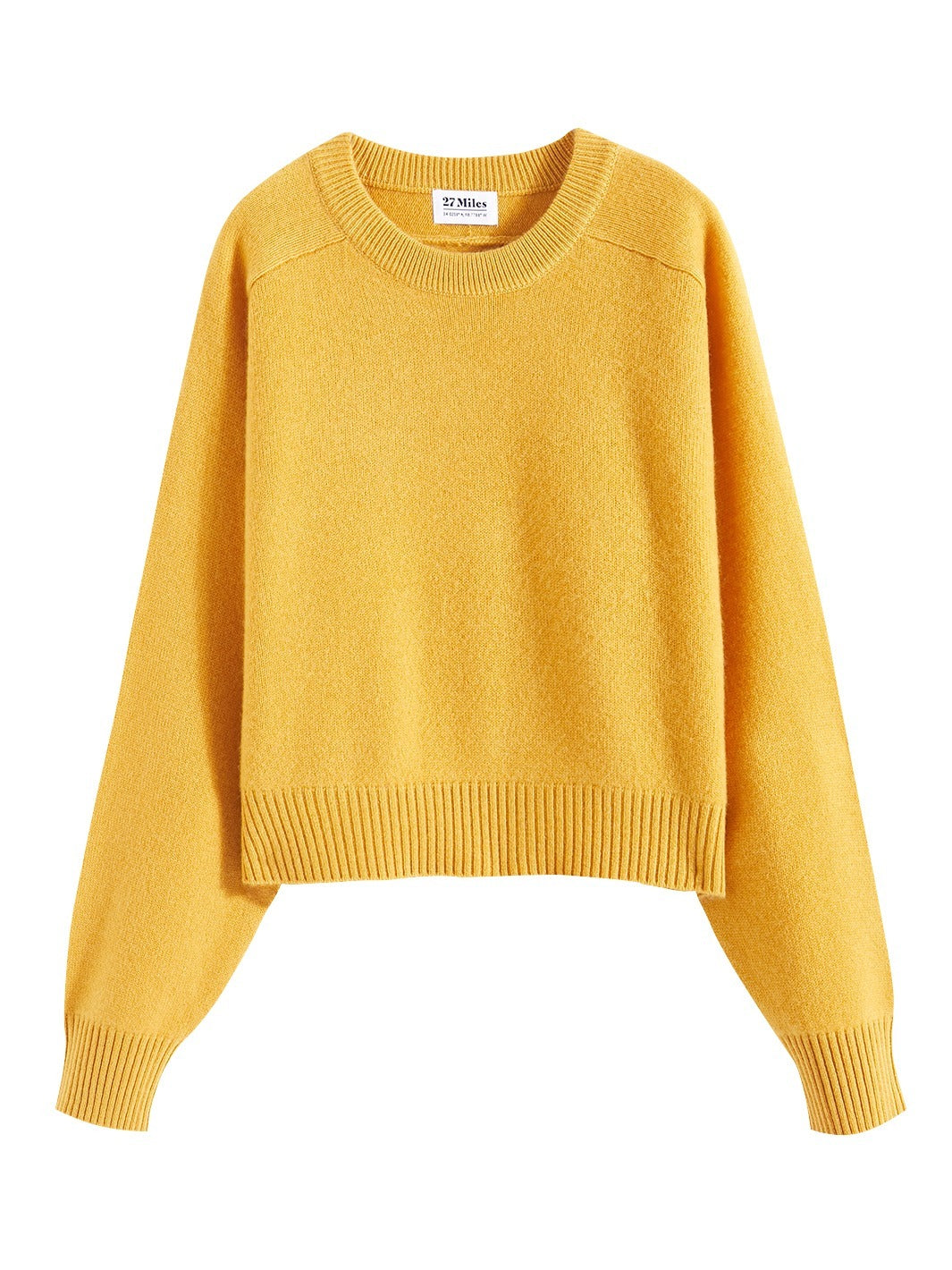 Flatlay photo of Iliana in marigold yellow. The sweater is cropped and oversized and made of 100% cashmere. The sweater also sports saddle sleeves and a crewneck with tall cuffs and bottom trims.