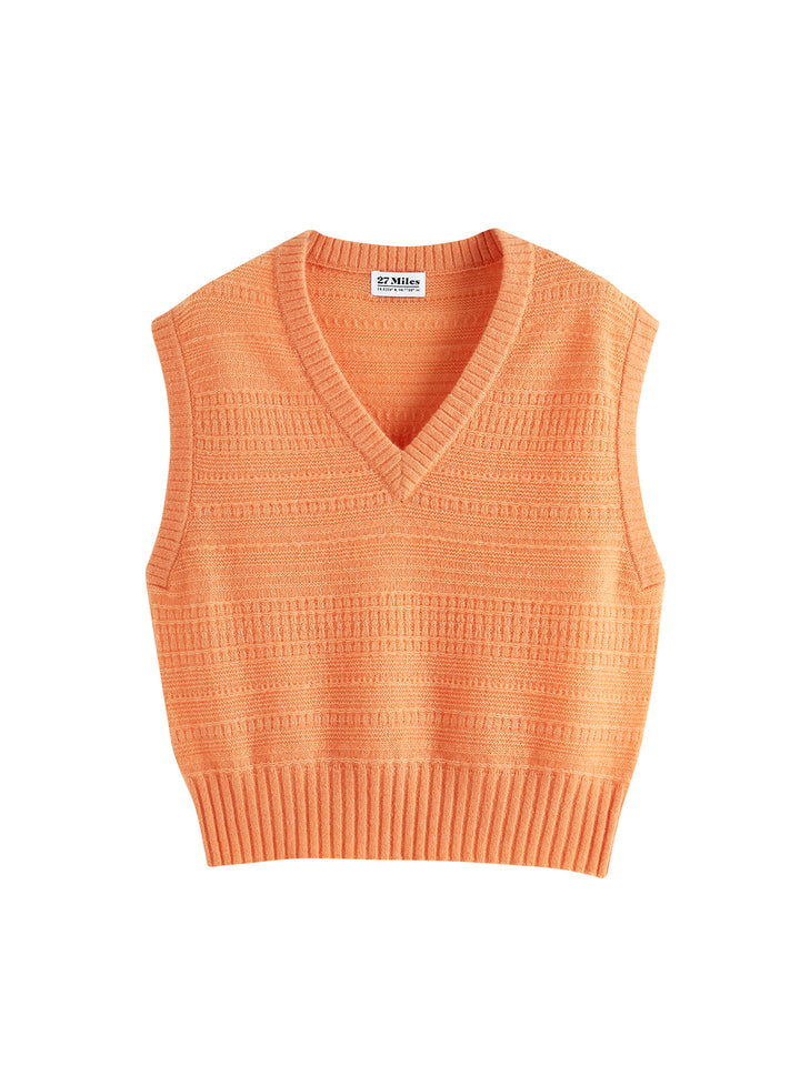 Flatlay photo of Amari in apricot orange. The sweater is straight and cropped and made of cashmere and silk. The vest has a subtle textured knit and v-neck.