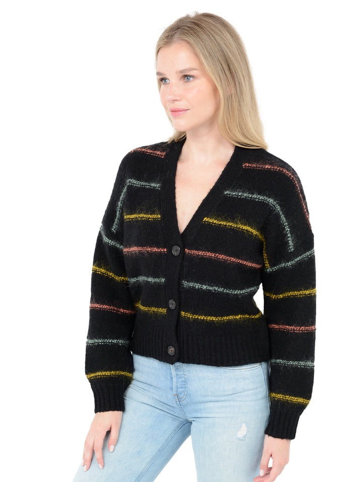 3/4 front facing shot of model wearing Micaela in black. The sweater is oversized and cropped and made of wool and cashmere with contrasting stripes in wool, nylon, and mohair.