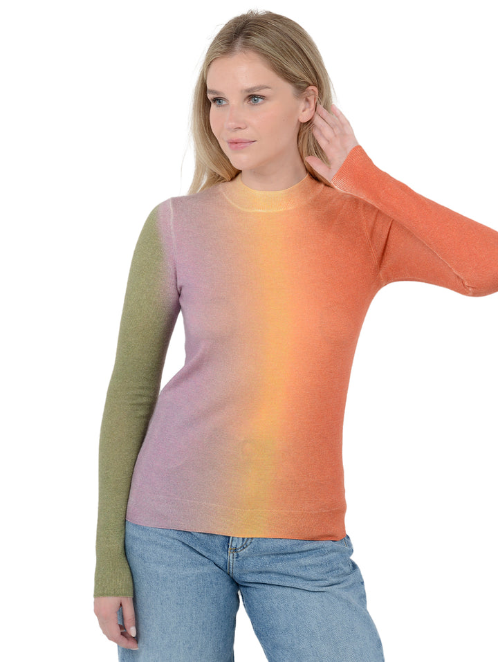 Alternate 3/4 front facing shot of model wearing Zorina in dayglow. The sweater is fitted and made of 100% cashmere. The sweater is a mock neck and features a horizontal gradient.