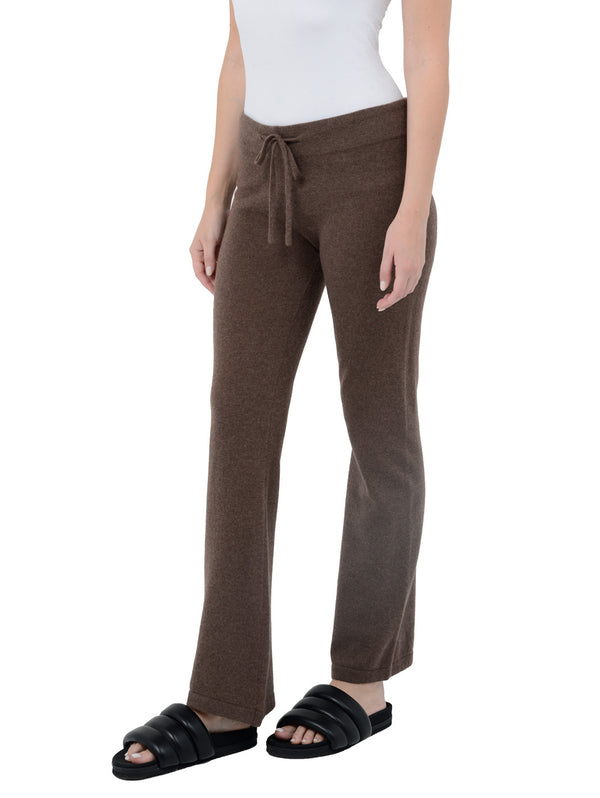 3/4 front facing shot of model wearing Kaite in cocoa brown. The lounge pants are straight fit and made of cashmere and recycled cashmere.