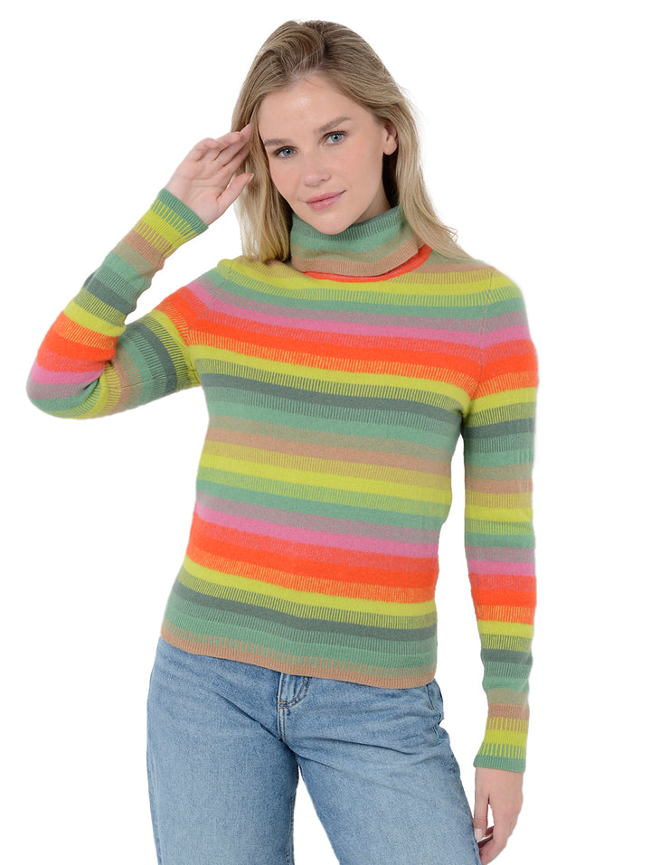 Front facing shot of model wearing Carina in jade rainbow stripes. The sweater is straight fit and made of 100% cashmere. The sweater is a striped turtleneck.