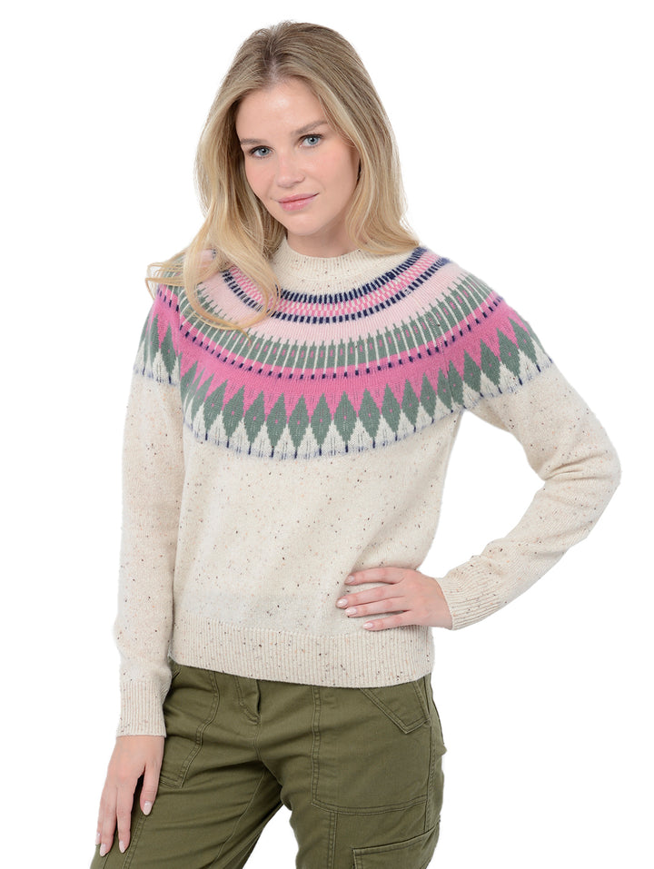 Front facing shot of model wearing Salena in Pebble Cream. The sweater is relaxed and made of 100% cashmere. The sweater also sports a fairisle knit design across the chest and neck.