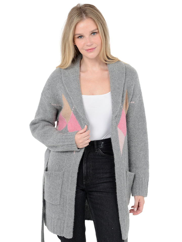 Alternate front facing shot of model wearing Tuscany in flannel grey with cardigan open. The sweater is long and oversized and made of wool, cashmere, and nylon. The sweater features a tie around the waist and patch pockets.