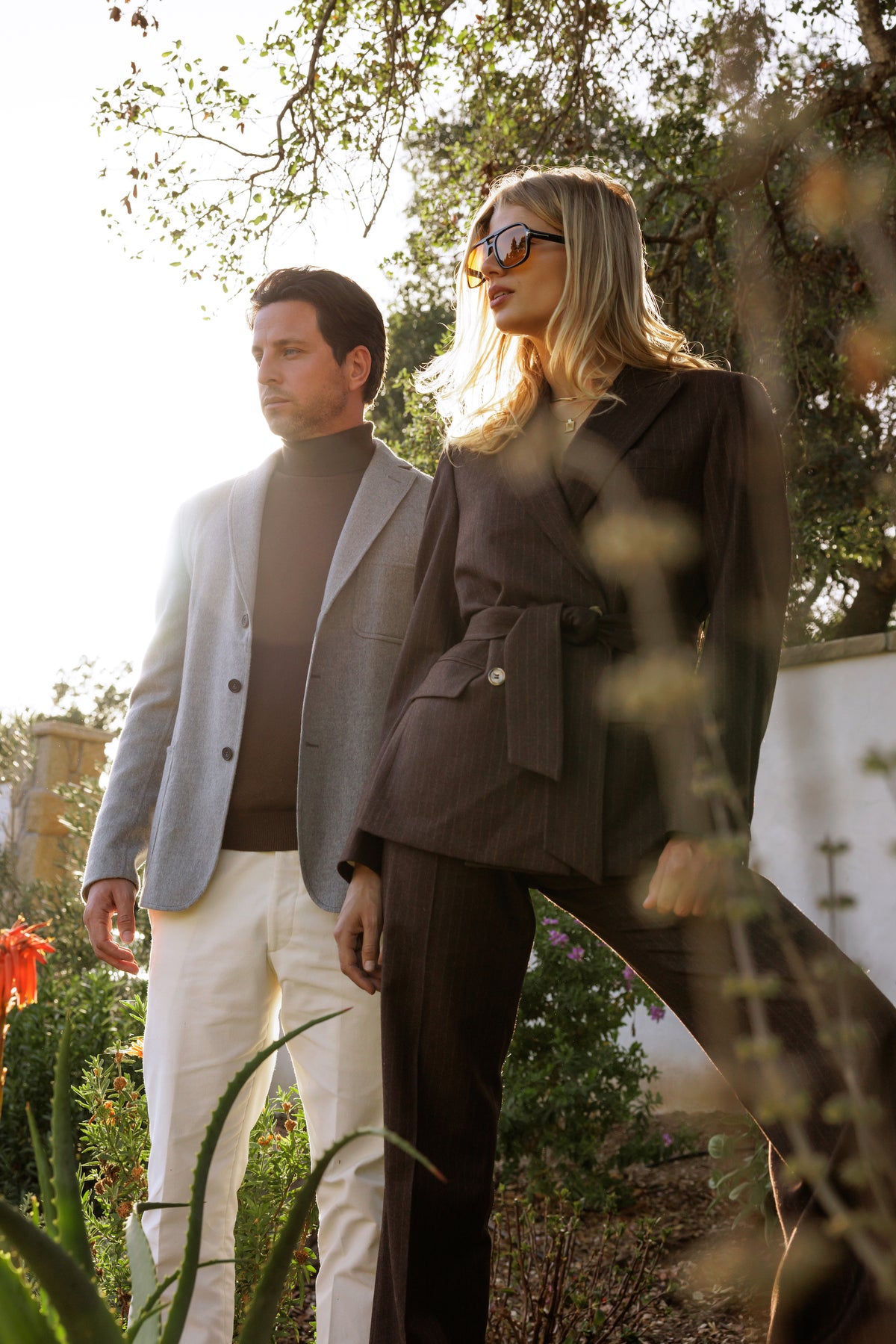 A woman and man wearing Vallorani tailored jackets outdoors